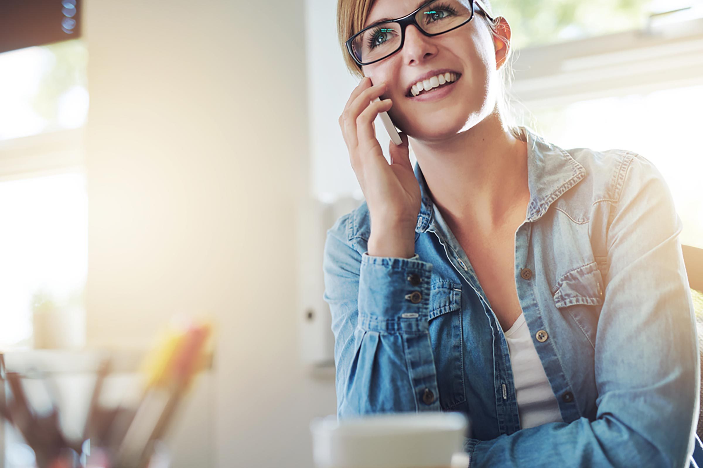 woman in glasses talking on phone
