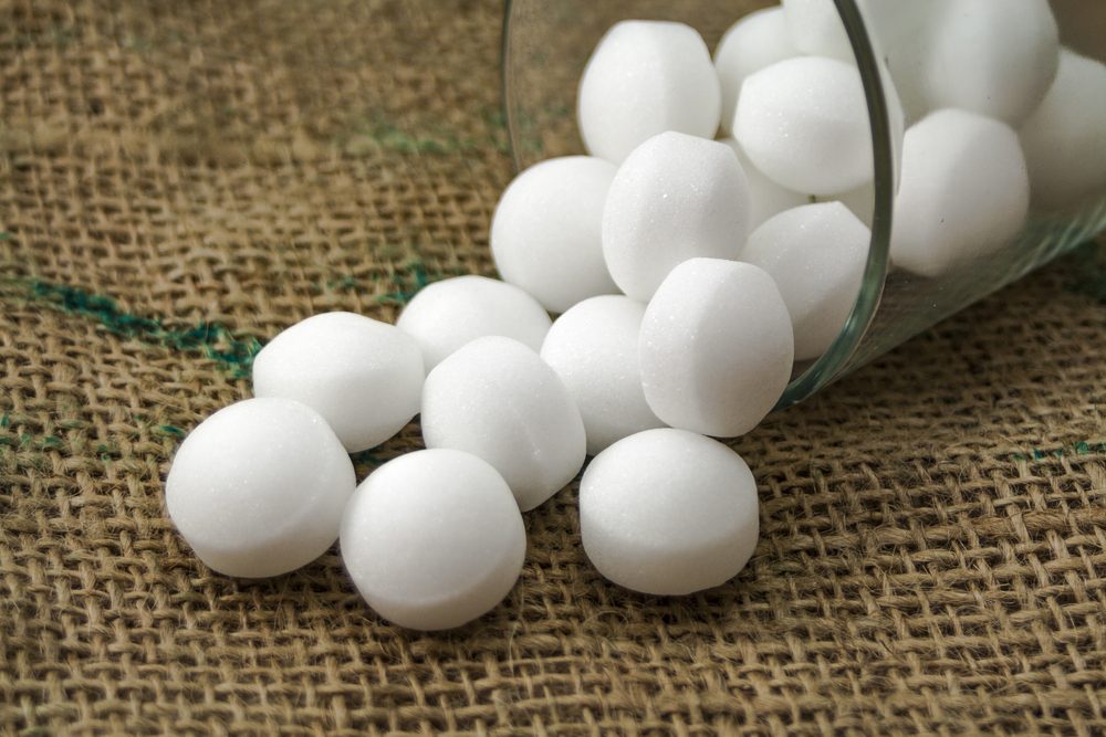 Moth balls in the glass over the sackcloth.