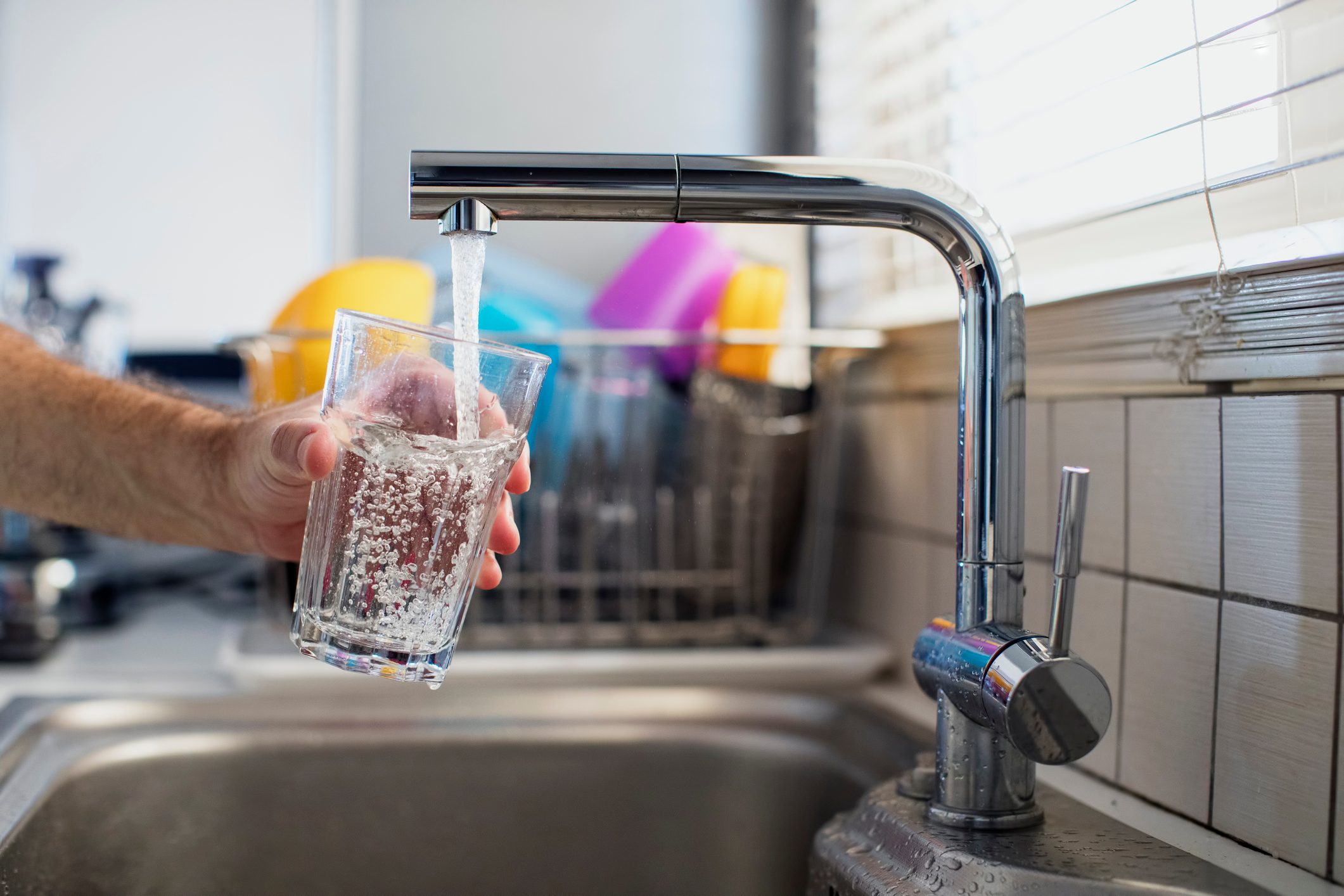 getting a glass of water from the sink