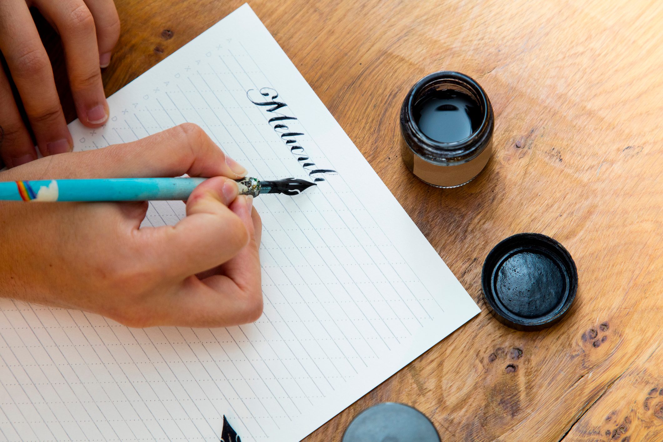 Woman writing with calligraphy pen