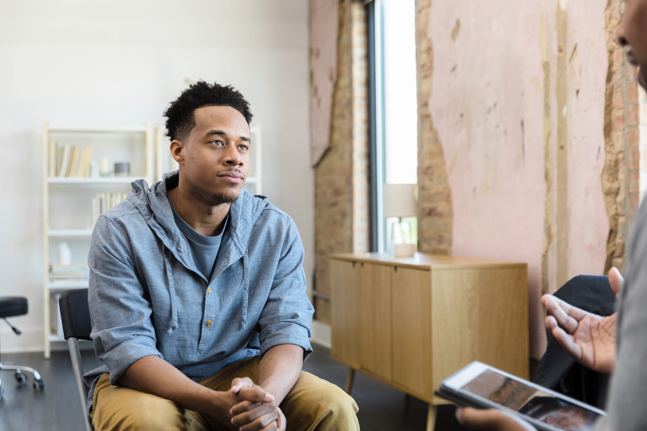Young adult male listens to his therapist