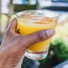woman holding orange juice
